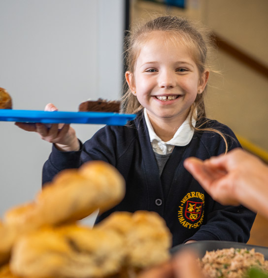 school girl smiling over dessert